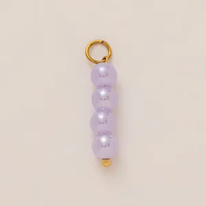 Detail of a lavender pearl shoe charm pendant with gold-plated stainless steel ring