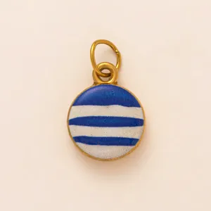 Close-up detail of a round stainless steel DIY charm with blue and white striped pattern