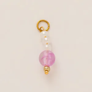Detailed view of a gold-plated stainless steel pendant with pearls and a purple bead.