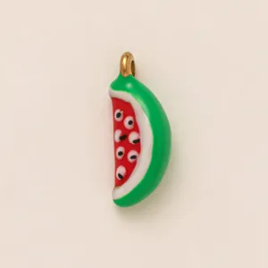 Detailed view of a whimsical ceramic watermelon charm with unique eye patterns for DIY