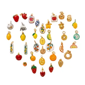 Assorted colorful stainless steel fruit charms for DIY jewelry arranged in a heart shape