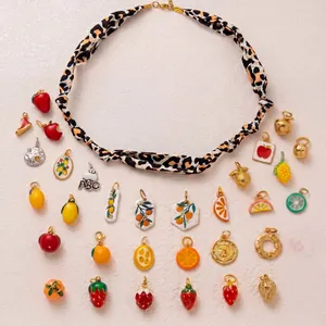 Detailed view of various colorful stainless steel fruit charms for DIY jewelry making