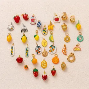Variety of colorful stainless steel fruit charms arranged in a heart shape for DIY jewelry.