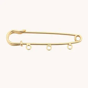 Detail of 14k gold plated safety pin brooch with DIY hanging loops for pendants.