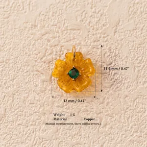 Detailed view of 12mm yellow flower pendant with green zircon and copper base