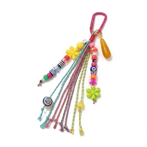 Detailed macro view of a colorful beaded bag charm featuring flower and star patterns
