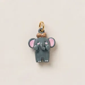 Close-up of a cute grey enamel painted elephant charm pendant with gold ring