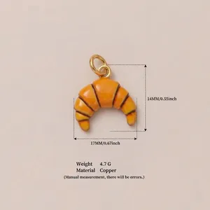 Detailed view of orange croissant charm with dimensions, material, and weight specifications