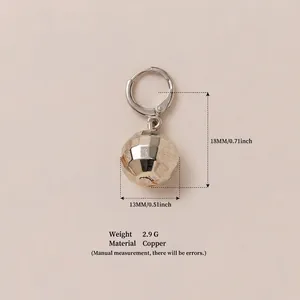 Close-up of faceted copper ball pendant earring with 18mm length measurement