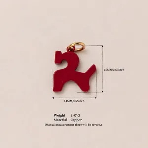 Detailed view of red enamel puppy pendant with 16mm height and 14mm width measurements