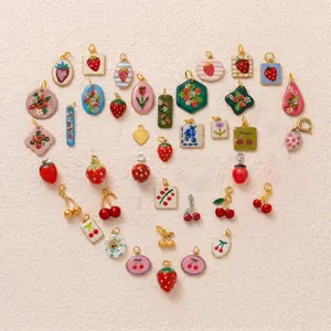 Detailed view of various cute strawberry and cherry fruit pendants for DIY jewelry making