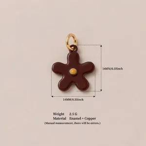 Macro view of 14mm brown enamel flower pendant with gold-plated copper loop for DIY jewelry
