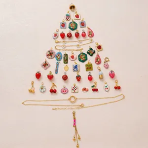 Detailed view of assorted strawberry and cherry enamel charms in a tree arrangement
