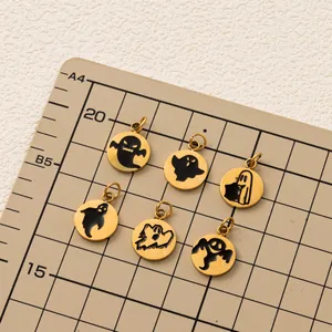 Macro view of six gold-plated stainless steel Halloween ghost pendants on a grid mat