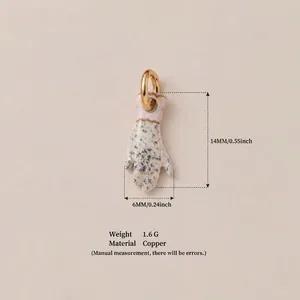Detailed view of hand-shaped pendant featuring a speckled glaze and dimensions.