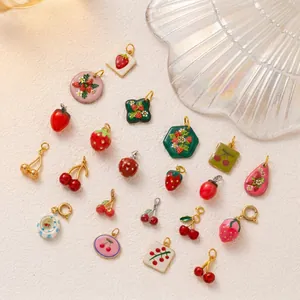 Detailed view of stainless steel fruit charms including strawberries and cherries for DIY jewelry.