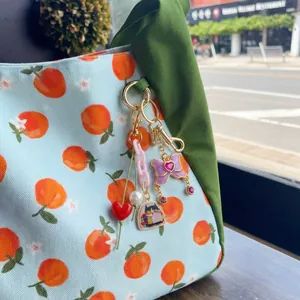 Close-up of elegant retro bag charm with heart, cat, and butterfly details