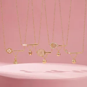 Detail of gold-plated sports theme necklaces with pearl and crystal badminton tennis charms