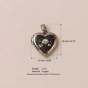 Detailed view of silver heart locket pendant with white floral design and measurements