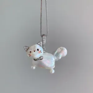 Macro close-up of a cute iridescent pearl cat pendant necklace with crystal ears