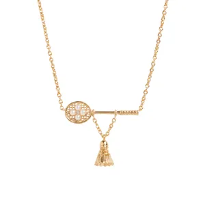 Detail view of gold badminton racket necklace with pearls and shuttlecock charm
