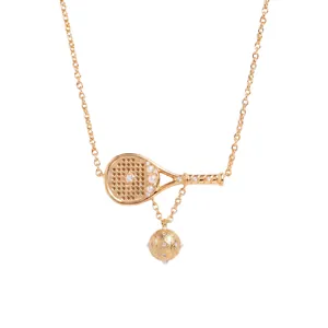 Detailed close-up of a golden sports-themed necklace with tennis racket and ball charms