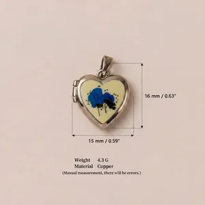 Detailed view of a vintage heart locket pendant with blue floral pattern and dimensions.