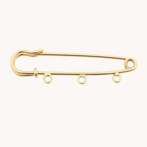 Close-up of 18K gold plated stainless steel safety pin with three loops for DIY charms