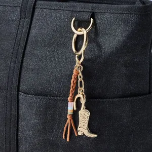 Detaillierte Nahaufnahme eines vergoldeten Cowboystiefel- und Hufeisen-Anhängers