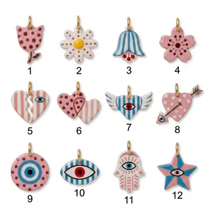 Twelve assorted acrylic pendants with double-sided floral and evil eye designs for DIY