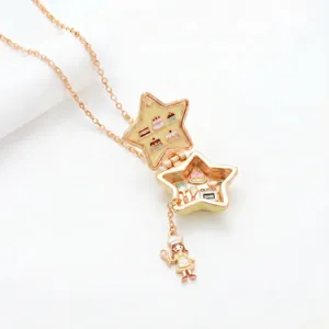 Golden star locket necklace featuring a miniature cake shop scene inside with a chef girl charm