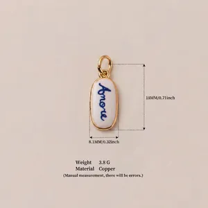 Gold-plated copper oval pendant accessory with blue Amore script on white enamel