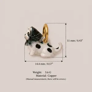 Close-up of a hand-painted spotted dog pendant with precise size and weight specifications