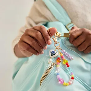 Stylish colorful DIY beaded keychain with heart charms and floral porcelain pendant for bags