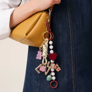 Fashionable DIY bag charm keychain with heart pendant and colorful beads on yellow bag