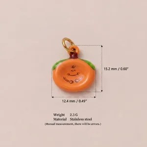 Close-up of a smiling persimmon pendant showing dimensions 15.2mm by 12.4mm