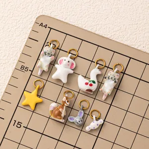 Various forest animal charms on a grid board for DIY jewelry and accessory making