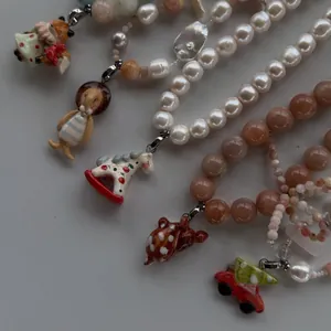 Handmade beaded necklaces with cute ceramic fox and rocking horse pendants.