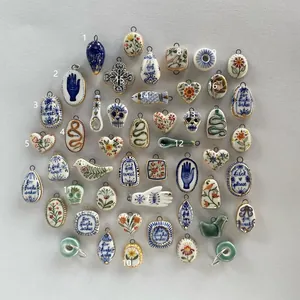 Collection of hand-painted ceramic charms with vintage patterns and English phrases