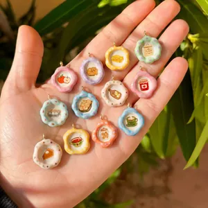 Close-up of colorful miniature ceramic plate pendants featuring cute food illustrations.