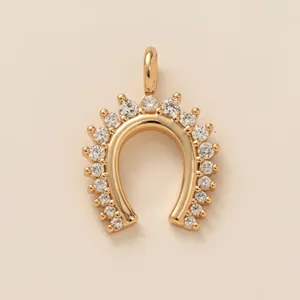 Elegant gold-plated horseshoe necklace pendant set with clear crystals in a minimalist style