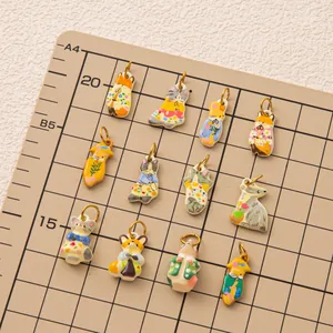 Set of 11 cute cartoon floral animal charms for DIY jewelry making on grid mat