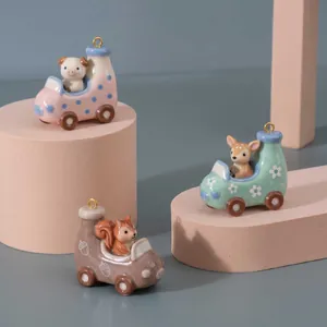 Detail view of ceramic cartoon animal car pendants including pig, deer, and squirrel