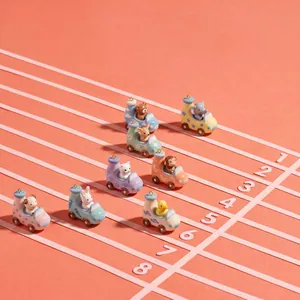Close-up detail of various cartoon animal car pendants on a miniature racing track scene