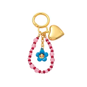 Ciondolo per borsa vintage con cuore dorato e perline a fiore blu, accessorio elegante