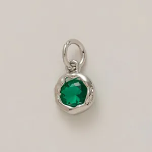 Silver-tone round charm with emerald green faceted stone for DIY jewelry making.