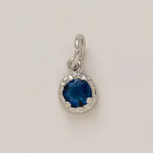 Elegant round silver-plated DIY charm pendant featuring a dark blue faceted gemstone