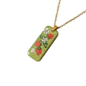Elegant 18K gold plated stainless steel necklace featuring a green strawberry pendant
