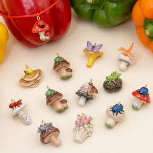 Detailed macro view of various hand-painted ceramic mushroom charms with colorful insects.
