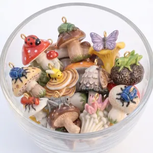 Close-up group shot of assorted colorful ceramic mushroom charms with insects in a bowl